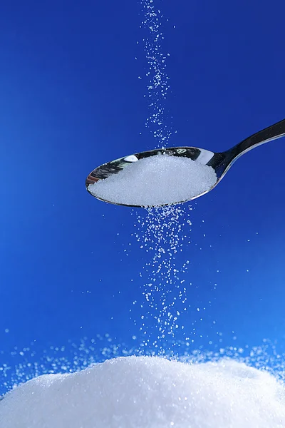 Sugar on blue background — Stock Photo, Image