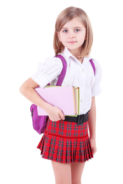 Beautiful little girl with backpack holding books isolated on white