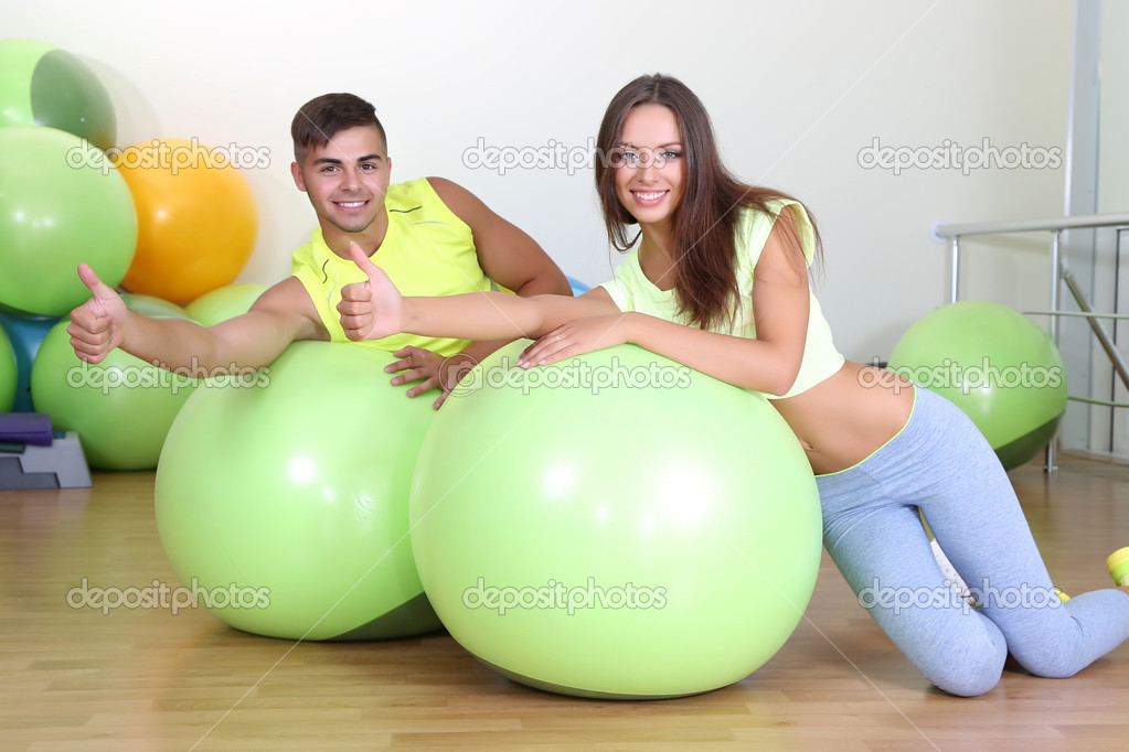 Girl and guy in fitness room