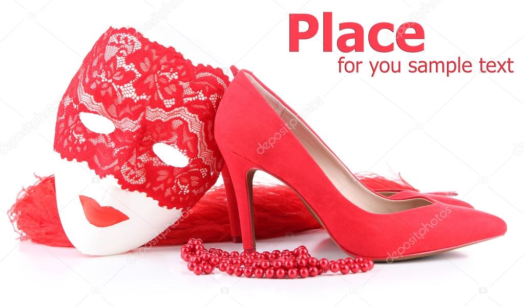 Beautiful red female shoes and carnival mask, isolated on white