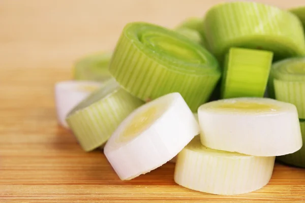 Sliced leek on wooden background — Stock Photo, Image