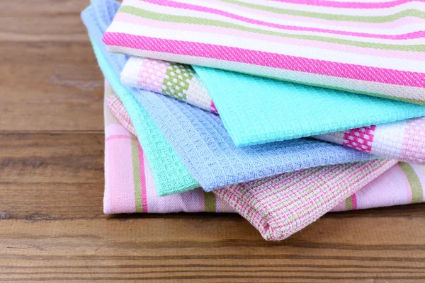 Kitchen towels on wooden background — Stockfoto