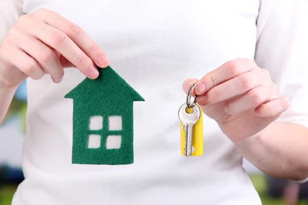 Little paper house in hand close-up, on bright background — Stock Photo, Image