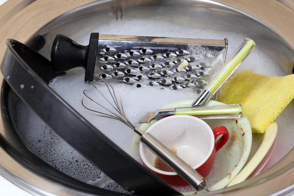 Utensils soaking in kitchen sink — Stock Photo, Image