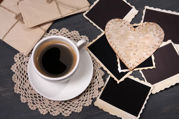 Composition with coffee cup, letters and old blank photos, on wooden background — Stock Photo, Image