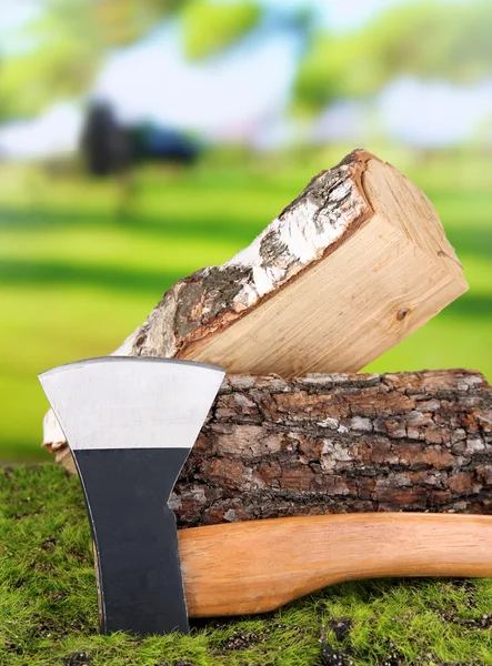 Ax and firewood on green grass, on nature background — Stock Photo, Image