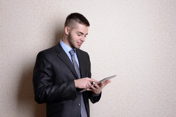 Portret van zakenman met Tablet PC in de buurt van muur — Stockfoto