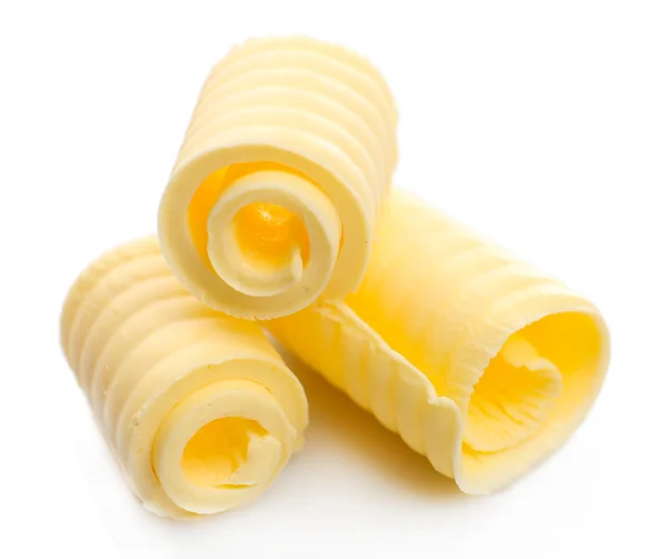 Curls of fresh butter, isolated on white — Stock Photo, Image