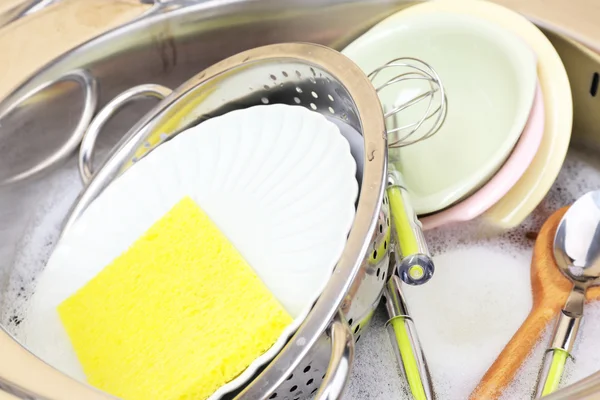 Utensils soaking in kitchen sink — Stock Photo, Image