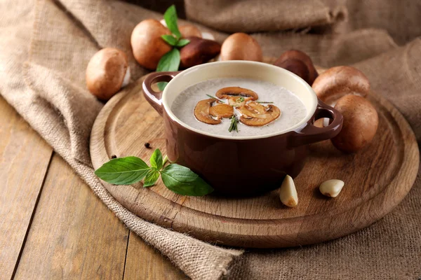 Composition with mushroom soup in pot, fresh and dried mushrooms, on wooden table, on sackcloth background — Stock Image Composition with mushroom soup in pot, fresh and dried mushrooms, on wooden table, on sackcloth background Royalty Free Stock Photos