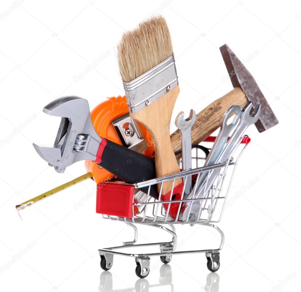 Construction tools in shopping cart isolated on white