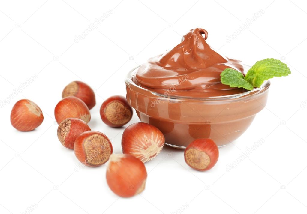 Sweet chocolate hazelnut spread with whole nuts and mint isolated on white