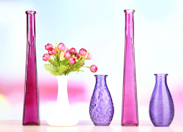 Different decorative vases on shelf on light background — Stock Photo, Image