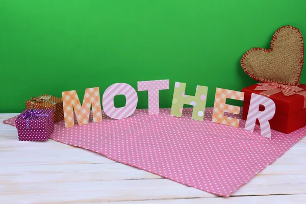 Mother- lettering of handmade paper letters on green background — Stock Photo, Image