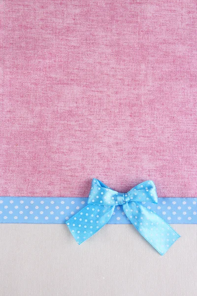 Color ribbon and bow on two color fabrics background — Stock Photo, Image