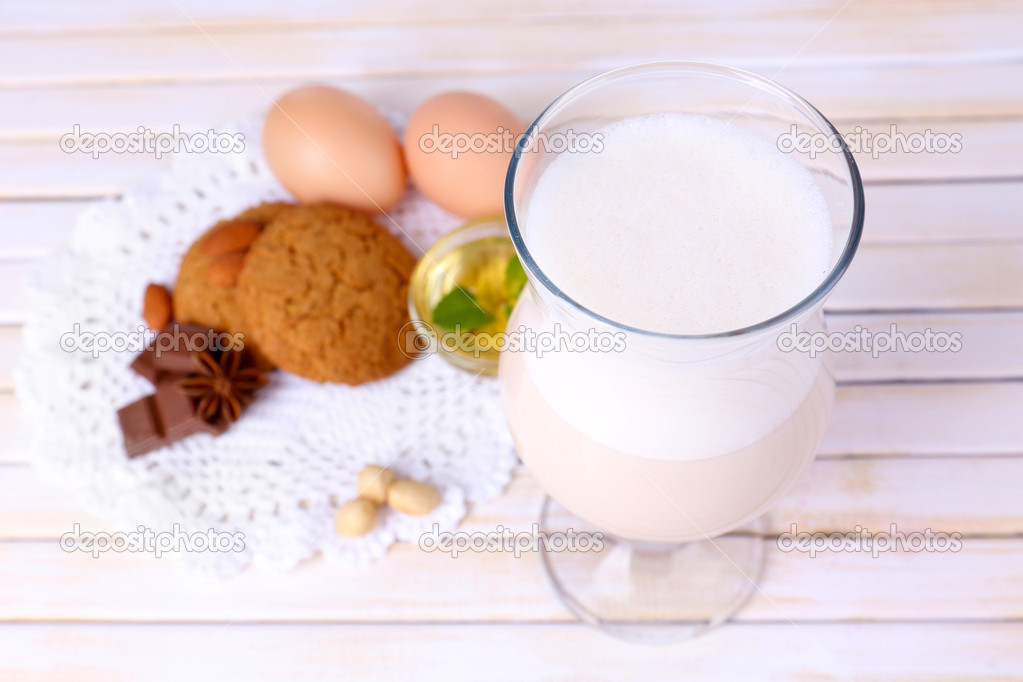 Eggnog with cookies on wooden table