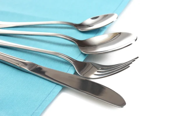 Fork, spoon and knife on a blue tablecloth — Stock Photo, Image