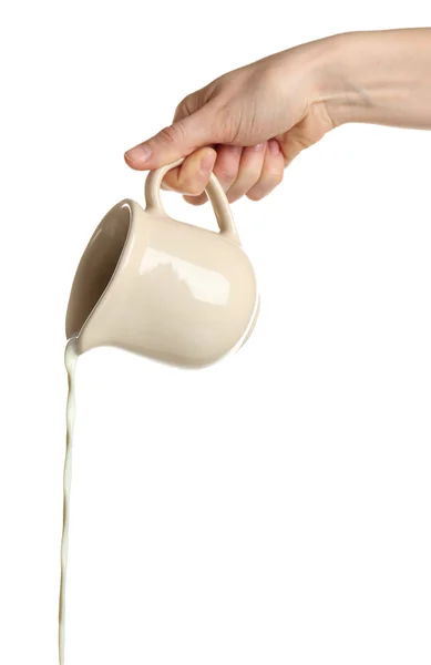 Pouring milk from pitcher, isolated on white — Stock Photo, Image