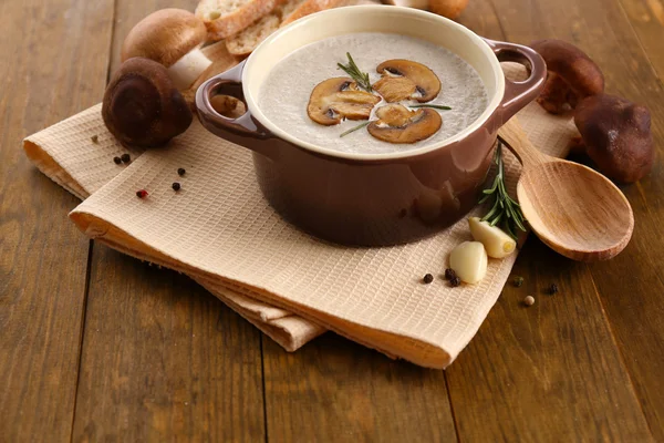 Mushroom soup in pot, on wooden background — Stock Photo, Image