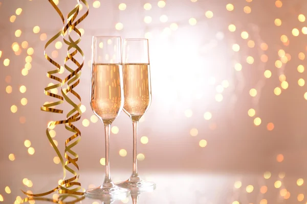 Glasses of champagne on shiny background — Stock Photo, Image