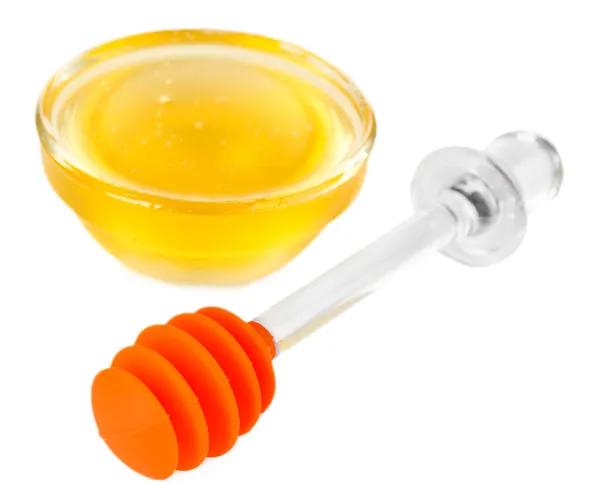 Miel dulce en cuenco de vidrio aislado en blanco — Foto de Stock