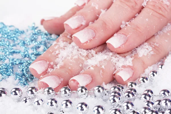 Hands with snow, snowflakes and beads closeup — Stock Photo, Image