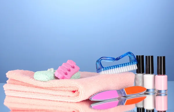 Pedicure set on pink towel on blue background — Stock Photo, Image