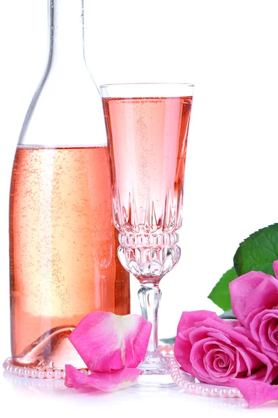 Composition with pink sparkle wine in glass, bottle and pink roses isolated on white — Stock Photo, Image