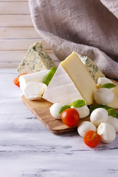 Ahşap masa üzerinde farklı lezzetli peynir — Stok fotoğraf