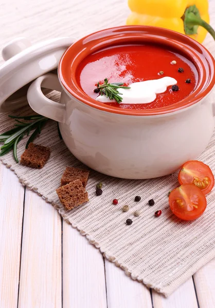 Tasty tomato soup and vegetables on wooden table — ストック写真