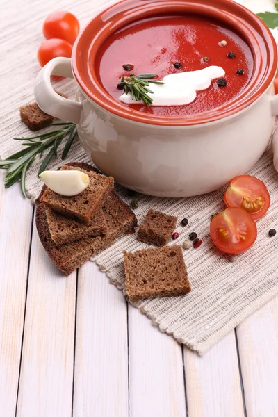 Tasty tomato soup and vegetables on wooden table — Stock Photo, Image