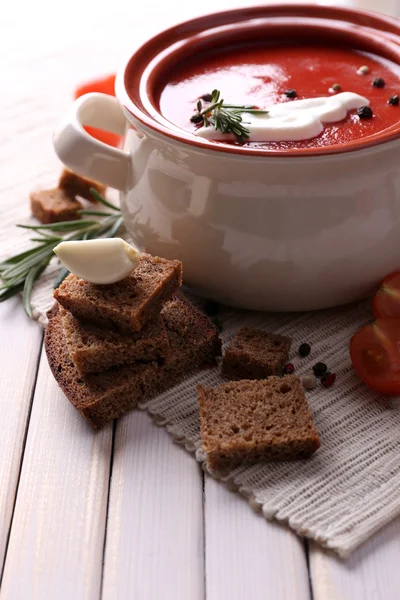 Tasty tomato soup and vegetables on wooden table — ストック写真