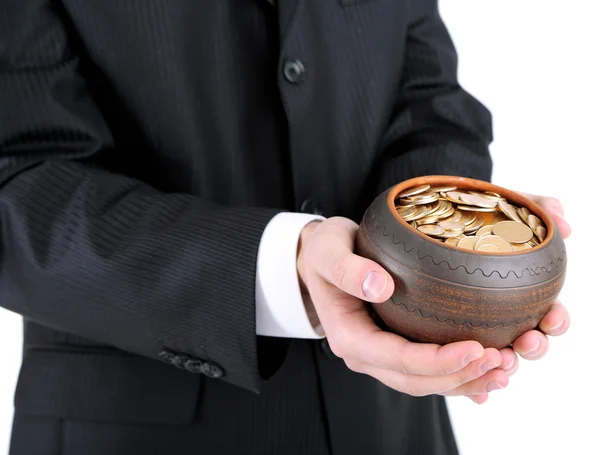 Keramische pot met gouden munten in mannelijke handen, geïsoleerd op witte achtergrond — Stockfoto