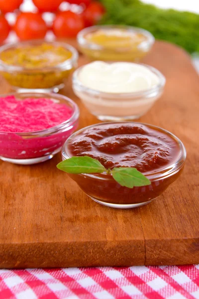 Various sauces on chopping board on table close-up — Stock Photo, Image