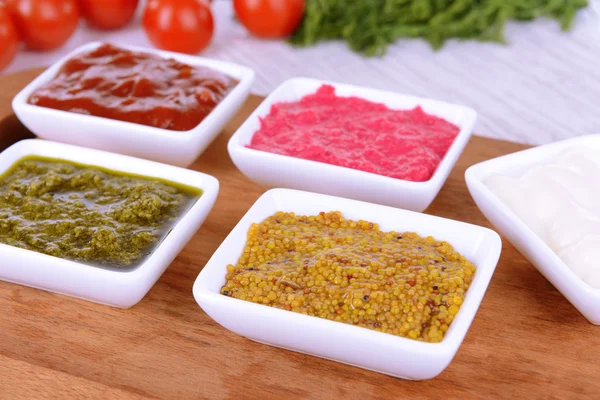 Varias salsas en la tabla de cortar en primer plano de la mesa — Foto de Stock