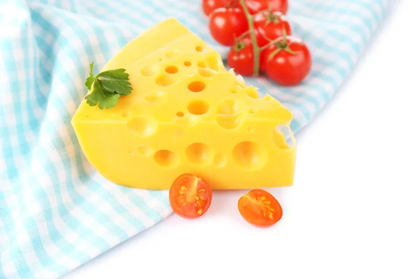 Piece of cheese and tomatoes,on color napkin, isolated on white — Stock Photo, Image