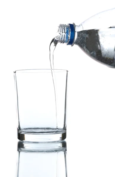 Pour water from bottle into  glass, on light blue background — Stock Photo, Image