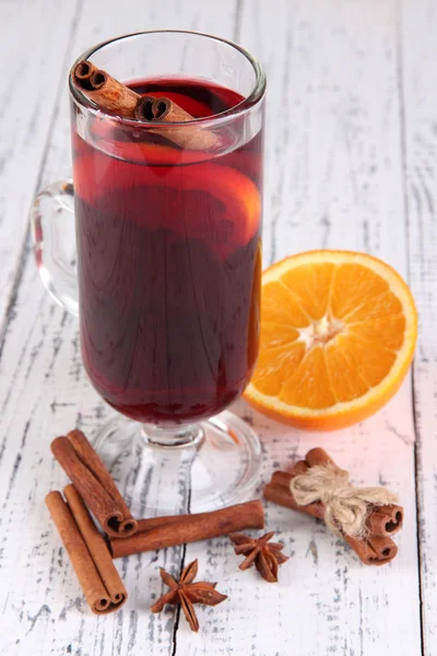 Mulled wine with oranges and spices on wooden background — Stock Photo, Image