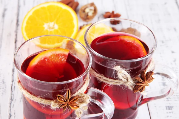 Mulled wine with oranges and spices on wooden background — Stock Photo, Image