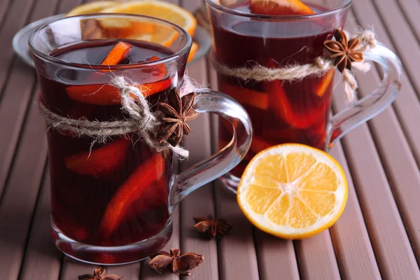 Mulled wine with oranges and spices on wooden background — Stock Photo, Image