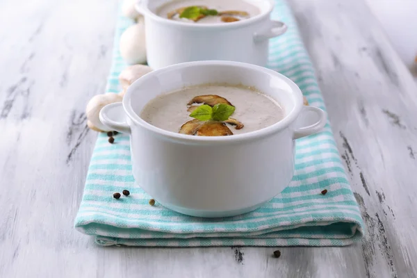 Mushroom soup in white pots, on napkin,  on wooden background — Stock Photo, Image