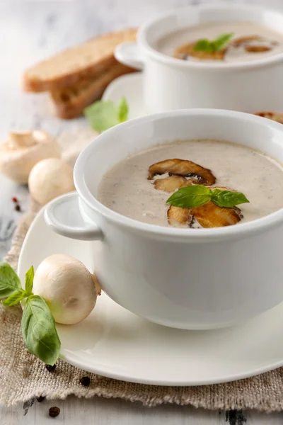 Mushroom soup in white pots, on napkin, on wooden background — Stock Photo, Image