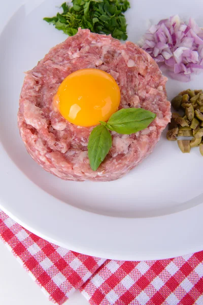 Delicious steak tartare with yolk on plate on table close-up — ストック写真