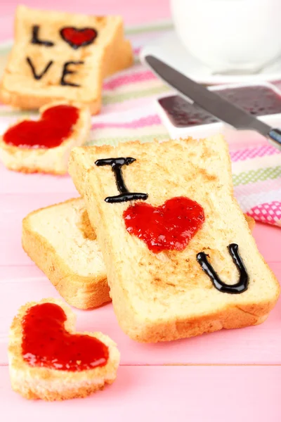 Delicious toast with jam and cup of tea on table close-up — Stock Photo, Image