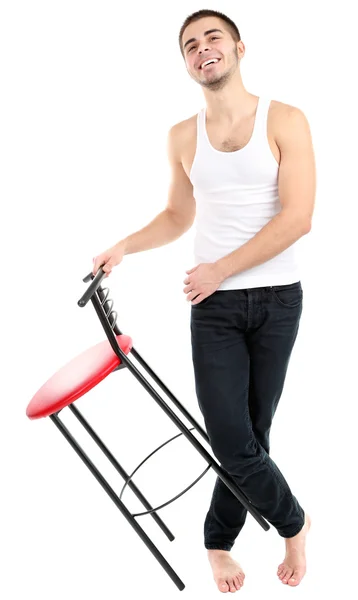 Handsome young man with chair isolated on white — Stock Photo, Image