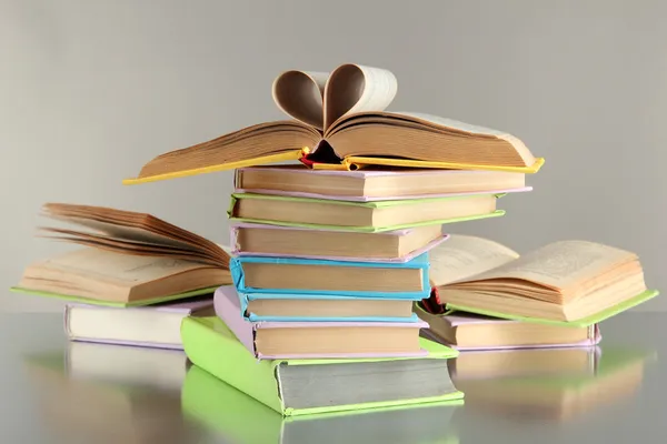 Stacks of books on grey background — Stock Photo, Image