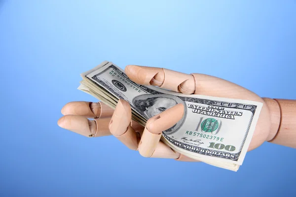 Money in wooden hand, on color background — Stock Photo, Image