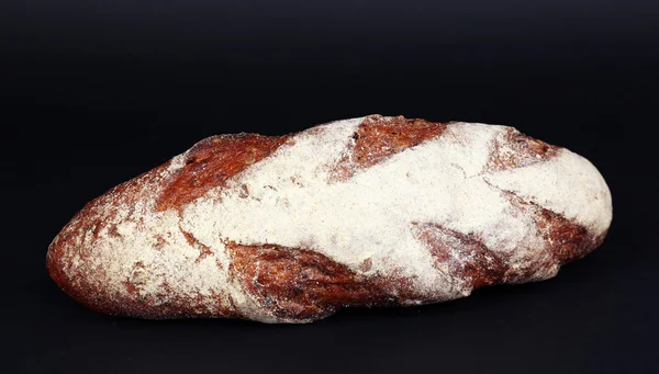 Loaf of bread on black background — Stock Photo, Image