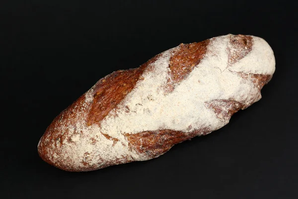 Loaf of bread on black background — Stock Photo, Image