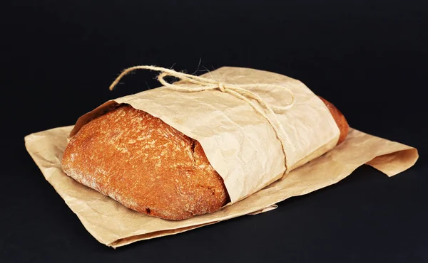 Loaf of bread on black background — Stock Photo, Image
